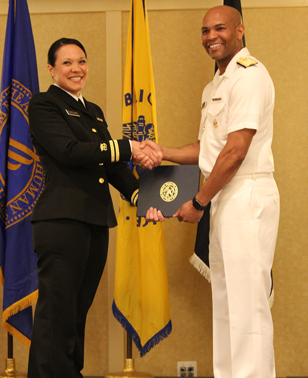 LT Rosario receiving her USPHS graduation certificate from U.S. Surgeon General Jerome Adams 