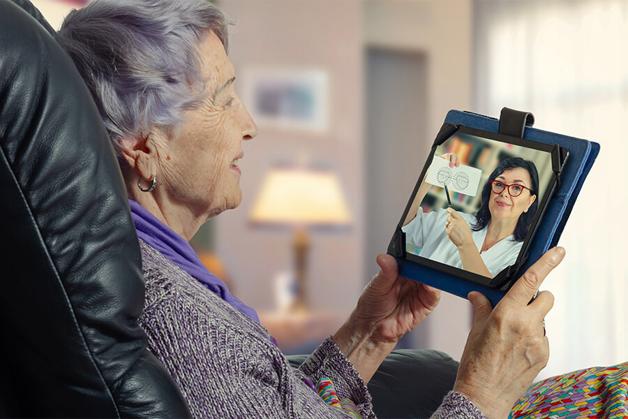 Elderly patient meets with a doctor for a telehealth appointment on her tablet.