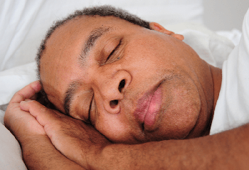 African American man sleeping in bed